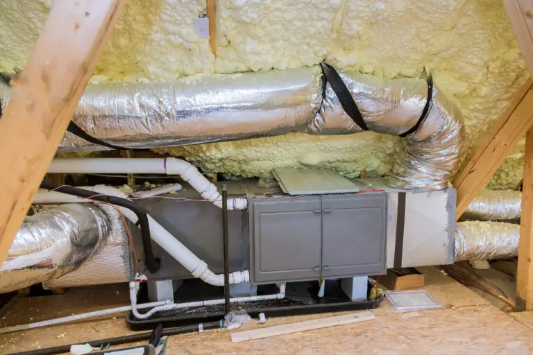 Wooden roof beams with insulates the attic with mineral wool and pipe heating system