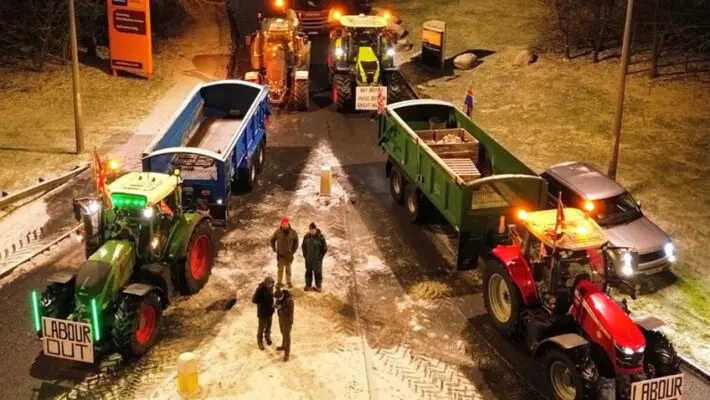 Farmers have staged a surprise overnight blockade of major supermarket distribution centres, escalating tensions over farmgate prices and the cost pressures facing UK food producers.