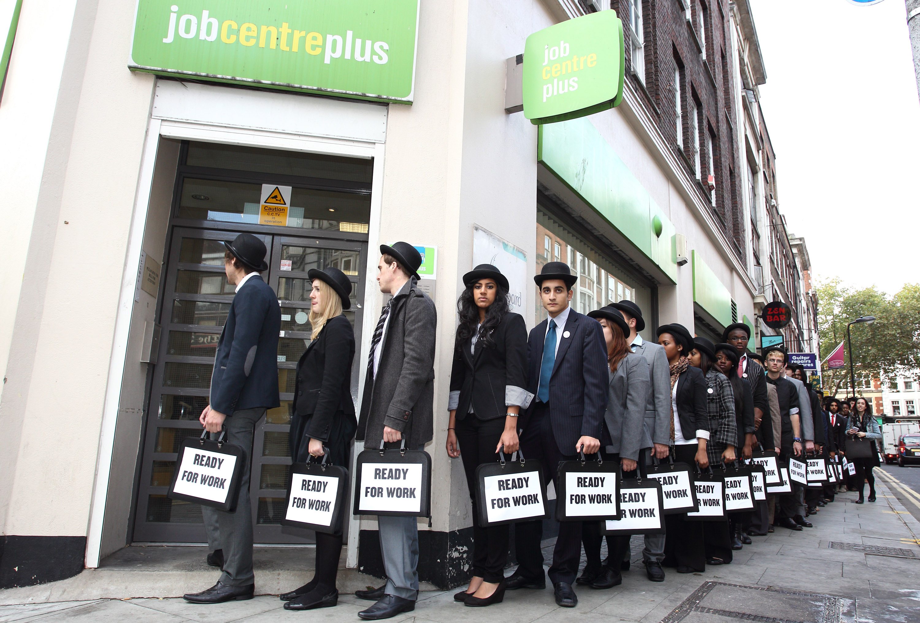 UK young unemployed congregate at job centre, London dressed in identical ‘ready for work’ suits to walk to Westminster to raise awareness of the million young people out of work in the UK