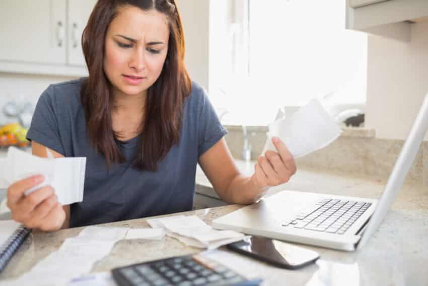 woman looking at bills