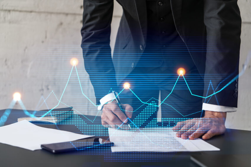 Businessman,In,Suit,Signs,Contract.,Double,Exposure,With,Financial,Chart