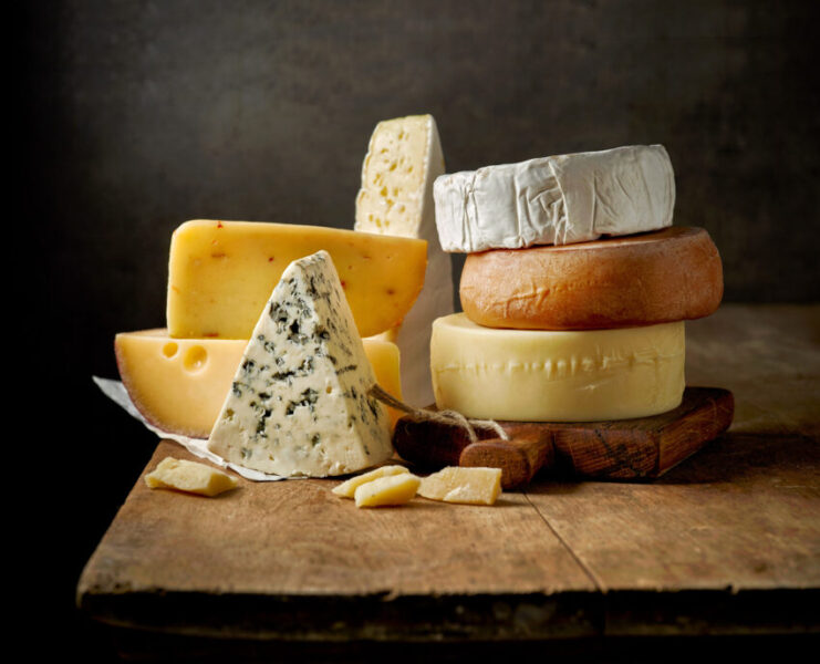 Various,Types,Of,Cheese,On,Rustic,Wooden,Table