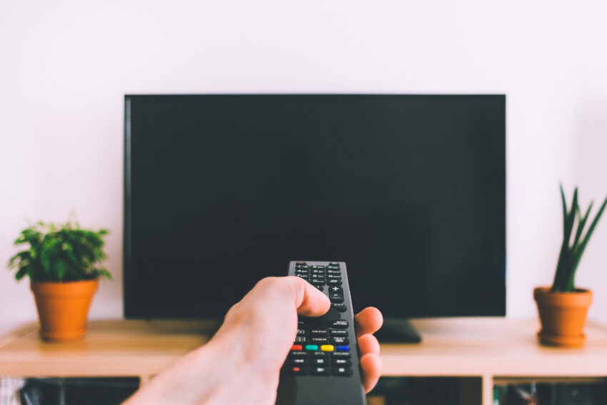 Television,With,Remote,Control,In,Hand,Mockup