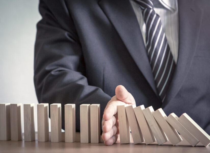 Management,Concept:,Manager,Hand,Stopping,The,Domino,Effect,On,Office