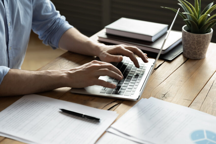Close,Up,Businessman,Using,Laptop,,Typing,On,Keyboard,,Sitting,At