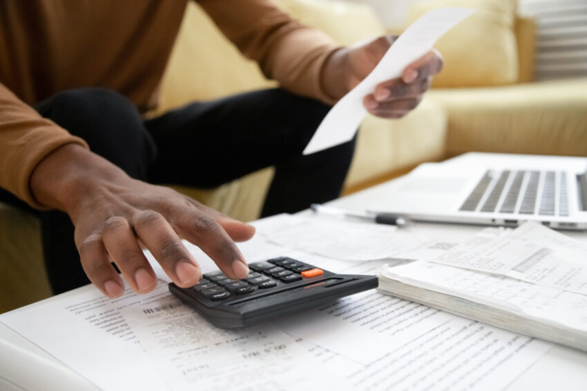 Close,Up,Of,African,American,Man,Calculating,Using,Machine,Managing