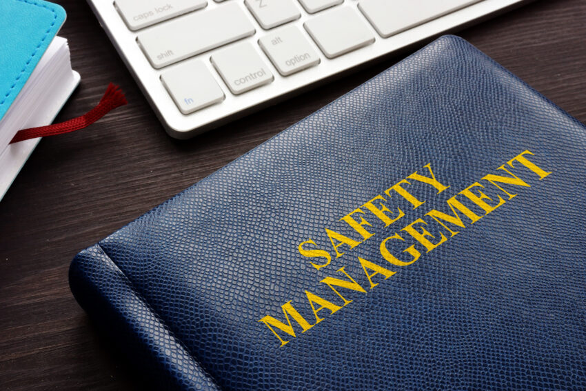 Safety,Management,Book,And,Keyboard,On,A,Desk.