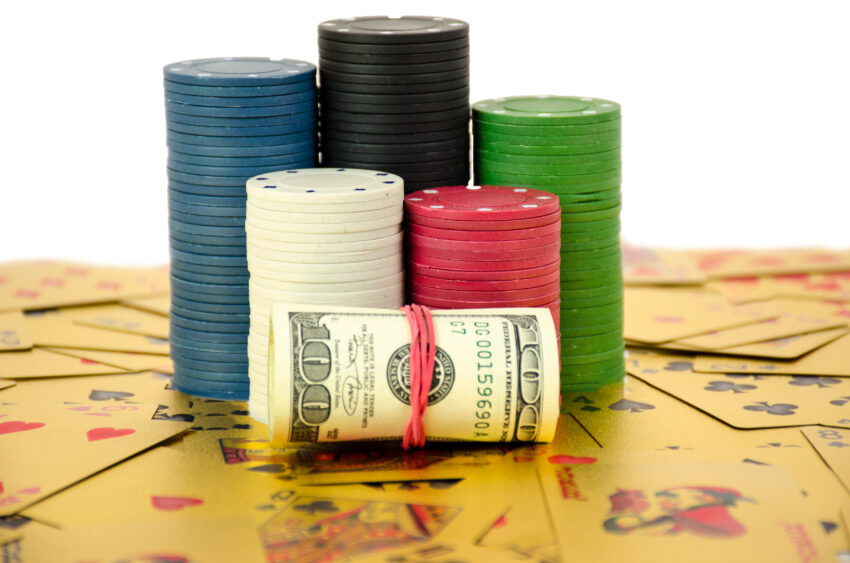 A,Stack,Of,Chips,Stays,On,Gold,Cards,With,Roll