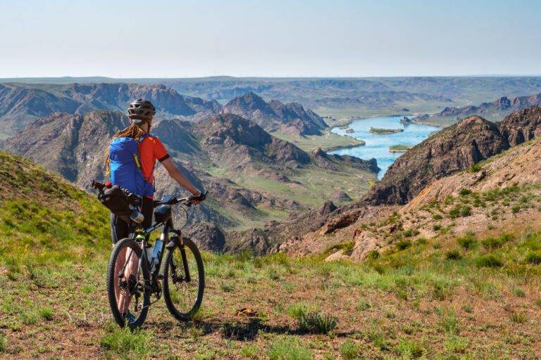 A,Traveler,Guy,On,A,Bicycle,Looks,Out,Over,A