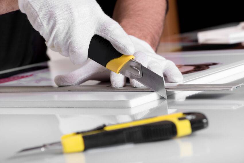 Professional,Hands,In,Gloves,Cutting,Off,Edges,Of,Printed,Photography