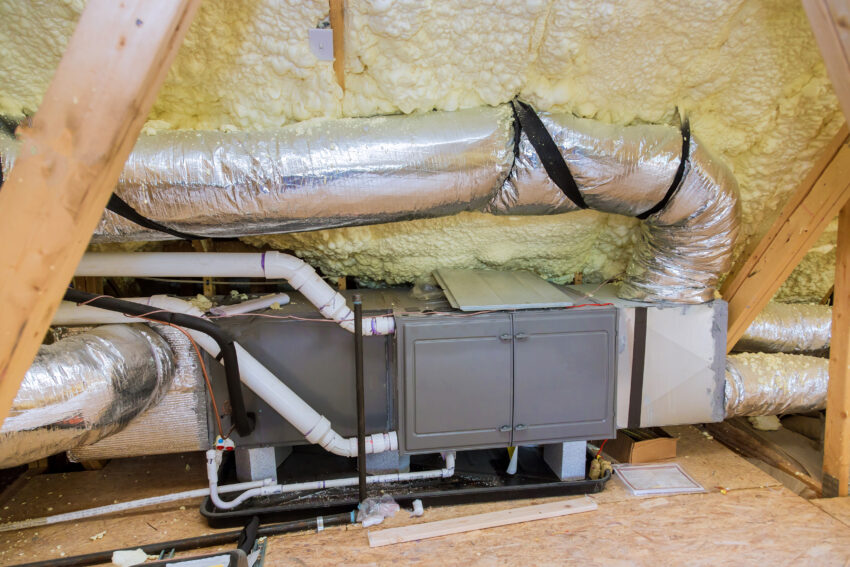 Wooden roof beams with insulates the attic with mineral wool and pipe heating system