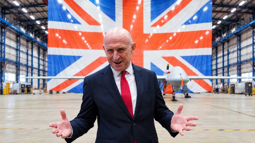 John Healey in front of a Union flag